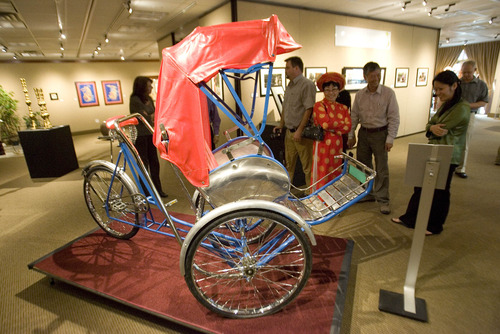 Paul Fraughton  |  The Salt Lake Tribune
Visitors to the Utah Cultural Celebration Center look at a "Tricyclo" a popular pedal-powered taxi from Vietnam. The center is hosting an exhibit highlighting  the art, music and artifacts of Vietnam, as well as a photo exhibit of images from Vietnam by photographer John Steele. Thursday, May 16, 2013