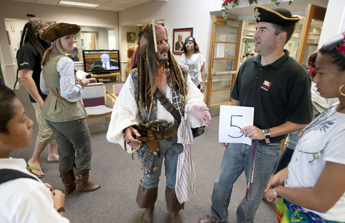 Steve Griffin | The Salt Lake Tribune

Captain Jack Sparrow, played by Robert Burbidge, joined Kearns High School students and senior citizens during  a pirate themed "Senior Prom." Students who have volunteered at the Kearns Senior Center held the prom with the seniors that included a scavenger hunt, talent show and the crowning of the king and queen of the prom. The prom was held at the Kearns Senior Center in Kearns, Utah Friday May 17, 2013.