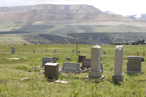 Paul Fraughton  |  The Salt Lake Tribune
The Bingham Canyon mine looks over the Bingham Cemetery where many of the men who worked the copper mine and their families  are buried.   Thursday, May 9, 2013