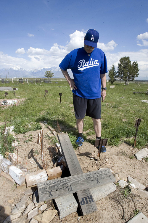 Paul Fraughton  |  The Salt Lake Tribune
Attorney Ron Yengich walks through the Bingham Cemetery where some of his relatives are buried. Concerned about the condition of the cemetery, he pauses to look at a wooden marker that has fallen.   Thursday, May 9, 2013
