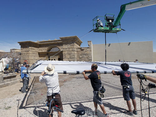 Al Hartmann  |  The Salt Lake Tribune
A crane and technical support team raise a giant reflector into place on the "Old Jerusalem" movie set near Elberta, Utah Wednesday May 22. The Church of Jesus Christ of Latter-day Saints is in the last few days of filming for the New Testament video library project (Bible Videos).