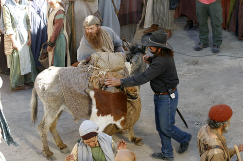 Al Hartmann  |  The Salt Lake Tribune
A donkey trainer-wrangler helps an actor keep an animal in place in a market scene on the "Old Jerusalem" movie set near Elberta, Utah Wednesday May 22. The Church of Jesus Christ of Latter-day Saints is in the last few days of filming for the New Testament video library project (Bible Videos).