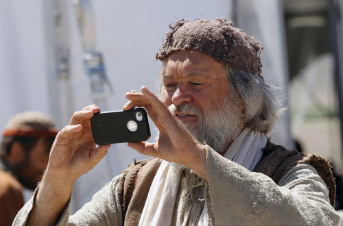 Al Hartmann  |  The Salt Lake Tribune
An actor on the "Old Jerusalem" movie set near Elberta, Utah photographs other extras Wednesday May 22. The Church of Jesus Christ of Latter-day Saints is in the last few days of filming for the New Testament video library project (Bible Videos).