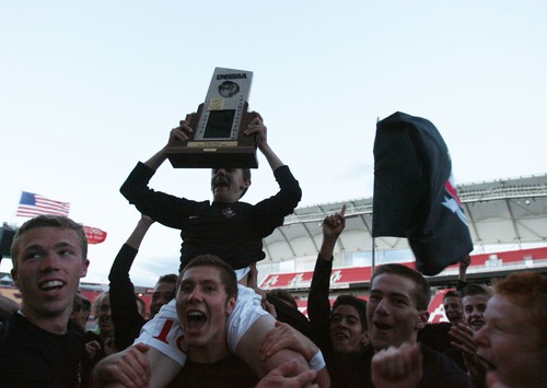 Kim Raff  |  The Salt Lake Tribune
Bountiful player Nick Rasmussen hoists the 4A State Championship trophy over his head as his team celebrates defeating Orem at Rio Tinto Stadium in Sandy on May 23, 2013. Bountiful won the game 2-0.