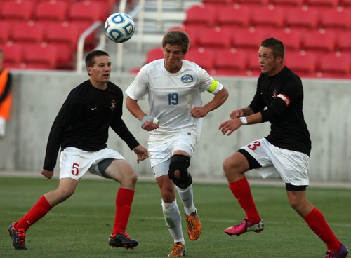 Kim Raff  |  The Salt Lake Tribune
Orem player Jonny Bradshaw tries to break through a double team by Bountiful players (left) Jake Haddock and (right) Carson Tinker during the 4A State Championship at Rio Tinto Stadium in Sandy on May 23, 2013. Bountiful went on to win the game 2-0.