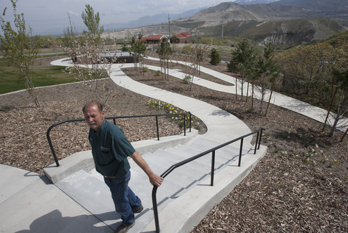 Steve Griffin  |  The Salt Lake Tribune
Arnold Warner, building and grounds supervisor, stands on a pathway at the top of the Utah Veterans Cemetery and Memorial Park's newly completed scatter garden at the Bluffdale cemetery. The scatter garden, where veterans ashes can be scattered,  an outdoor Columbarium, an electronic gravesite locator kiosk are a few of the cemetery's $5 million improvement project.