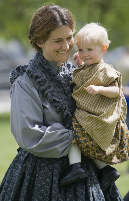 Jim Urquhart  |  The Salt Lake Tribune
Playing the part of a launderss, Rachel Crane of Heber carries her one-year-old son Emmitt Crane Saturday, May 29 2010 at a Civil War encampment in Fairfield.  Camp Floyd State Park in conjunction with the Utah Territorial Civilian Commission and Utah Civil War Association are hosting a Civil War Encampment Memorial Day Weekend at Camp Floyd State Park. The event allows visitors to experience camp life and participate in several activities performed by soldiers of the Civil War. Events include reenactments, encampments, storytelling, stagecoach rides, firearm and cannon demonstrations, marches, drills, 1861 period games, and photos in period uniform. 5/29/10