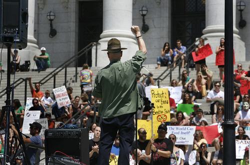 Scott Sommerdorf  |  The Salt Lake Tribune
Marine Corps veteran Aaron Davis speaks Saturday at a protest at the Utah Capitol against genetically modified foods produced by seeds from Monsanto. The March Against Monsanto was one of many held at state capitals in the United States and in other countries.