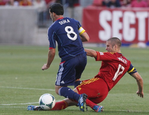 Kim Raff  |  The Salt Lake Tribune
(right) Real Salt Lake defender Chris Wingert (17) slides to free the ball from (left) Chicago Fire midfielder Dilly Duka (8) during the first half of the match at Rio Tinto Stadium in Sandy on May 25, 2013.