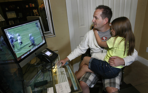 Scott Sommerdorf   |  The Salt Lake Tribune
Sam Gordon watches a set of videos of her playing football, set to music by her father Brent Gordon, Wednesday, May 15, 2013. Gordon, who's now 10, became famous as a girl playing football against boys. The story blew up, to where she attended the Super Bowl as the NFL commissioner's guest, to cite just one example.