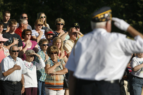 Scott Sommerdorf   |  The Salt Lake Tribune
Salem residents stand as the national anthem is sung at the Memorial Day ceremony, at the Salem City Cemetery, Monday May 27, 2013. Salem is the hometown of Utah soldier Spc. Cody Towse, who died last week in Afghanistan.
