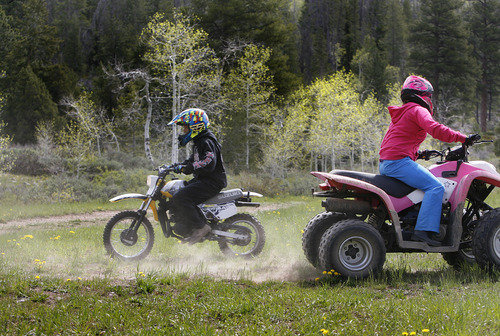 Scott Sommerdorf  |  The Salt Lake Tribune
Skyler Lee, left, and Arianne Anderson enjoy off-road activities near their family camp just off the Mirror Lake Highway. State Road 150 is now open just in time for the Memorial Day weekend, Sunday, May 26, 2013.