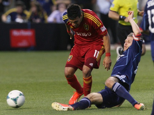 Kim Raff  |  The Salt Lake Tribune
(left) Real Salt Lake midfielder Javier Morales (11) has the ball kicked away from his feet by (right) Chicago Fire midfielder Logan Pause (12) during the second half of the match at Rio Tinto Stadium in Sandy on May 25, 2013. The match ended in a 1-1 tie.