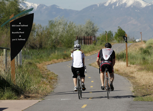 Al Hartmann  |  The Salt Lake Tribune
Folks take a bicycle ride along the Legacy Highway's multi use Bicycle/Pedestrian/Equestrian Trail near the Pages Lane Trailhead Tuesday May 21.  Dozens of lead and arsenic samples along rails-to-trails routes, including the Denver & Rio Grande Trailhead along the Great Salt Lake and the Historic Union Pacific Trail in Park City, are up to 15 times higher than safe levels.