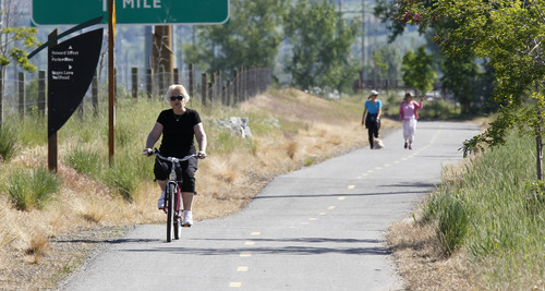 Al Hartmann  |  The Salt Lake Tribune
A bicycle rider and walkers take some excercise along the Legacy Highway's multi use Bicycle/Pedestrian/Equestrian Trail near the Pages Lane Trailhead Tuesday May 21. Dozens of lead and arsenic samples along rails-to-trails routes, including the Denver & Rio Grande Trailhead along the Great Salt Lake and the Historic Union Pacific Trail in Park City, are up to 15 times higher than safe levels.