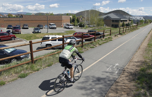 Al Hartmann  |  The Salt Lake Tribune
A bicyclist takes a ride along Park City's Union Pacific Trail near Bonanza Drive Tuesday May 21. Dozens of lead and arsenic samples along rails-to-trails routes, including the Denver & Rio Grande Trailhead along the Great Salt Lake and the Historic Union Pacific Trail in Park City, are up to 15 times higher than safe levels.