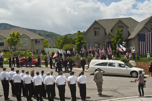 Chris Detrick  |  The Salt Lake Tribune
Family, friends and community members watch as the body of Elk Ridge Army medic Cody Towse is carried into his home by members of the Utah Army National Guard Funeral Honors Team Wednesday May 29, 2013. Towse, 21, died May 14 near Sanjaray, Afghanistan, when an improvised explosive device (IED) detonated as he rushed to provide medical care to a wounded soldier. He was one of four soldiers on foot patrol who died in a series of four IED blasts that day, including two men assigned with Towse to the 3rd Battalion, 41st Infantry Regiment, 1st Brigade Combat Team, 1st Armored Division from Fort Bliss, Texas.