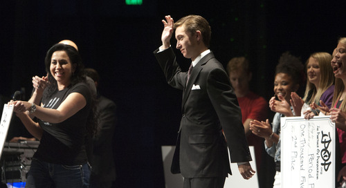 Steve Griffin  |  The Salt Lake Tribune
First-place winner Sean O'Bryant waves to the crowd after being announced as the winner of Alta High School's first "Hawk Tank" mobile app idea competition Friday. His app, iScholarship, is designed to help students find scholarships for college. Sponsored by the IPOP Foundation, the contest played off the popular television show, "Shark Tank," in which entrepreneurs pitch ideas and business plans.