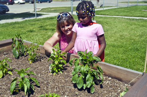 Chris Detrick  |  The Salt Lake Tribune
Keri Jones and Glory Ella Gleave, 3, look at their garden in Salt Lake City.