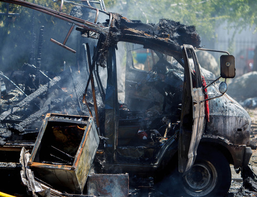 Trent Nelson  |  The Salt Lake Tribune
Firefighters extinguish a fire that burned a van belonging to Harvey Dunn, in Salt Lake City Friday May 31, 2013.