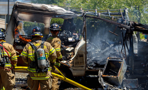 Trent Nelson  |  The Salt Lake Tribune
Firefighters extinguish a fire that burned a van belonging to Harvey Dunn, in Salt Lake City Friday May 31, 2013.