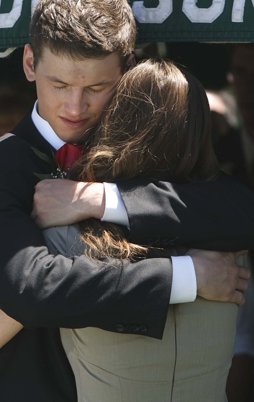Leah Hogsten  |  The Salt Lake Tribune
Will Towse hugs his sister, Callan, 17, at the graveside of their brother Spec. Cody Towse on Saturday in Salem. Funeral services for the Army medic, who was killed by an improvised explosive device in Afghanistan May 14, were held at Salem Hills High School in Salem, Utah, Saturday, June 1, 2013.