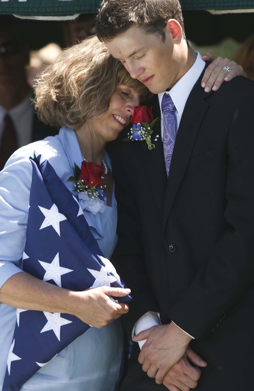 Leah Hogsten  |  The Salt Lake Tribune
Jamie Towse hugs her son Will, 20, at the graveside of her oldest son, Spc. Cody Towse, on Saturday at the Salem City Cemetery. Funeral services for the Army medic, who was killed by an improvised explosive device in Afghanistan May 14, were held at Salem Hills High School in Salem, Utah, Saturday, June 1, 2013.