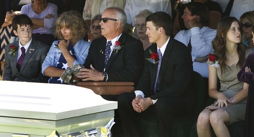Leah Hogsten  |  The Salt Lake Tribune
Christian Towse, 14, his mother, Jamie, father, Jim, brother Will, 20, and sister Callan, 17, at the graveside of their brother and son Spc. Cody Towse. Funeral services for the Army medic, who was killed by an improvised explosive device in Afghanistan May 14, were held at Salem Hills High School in Salem, Utah, Saturday, June 1, 2013.