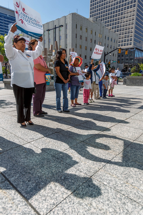 Trent Nelson  |  The Salt Lake Tribune
Attendees hold signs at a prayer vigil for immigration reform at the Federal Building in Salt Lake City on Thursday.