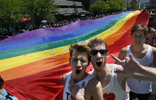 Scott Sommerdorf   |  The Salt Lake Tribune
Nico Ridiuejo, left, and Matt Petersen, cheer while helping to carry the rainbow flag at the end of the Utah Pride Festival's Gay Pride Parade through the streets of downtown Salt Lake City, Sunday, June 2, 2013.