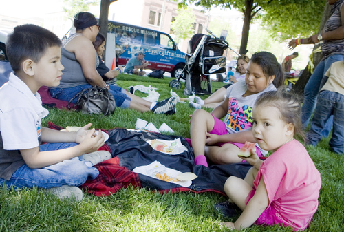 Keith Johnson | The Salt Lake Tribune

Alex Iron (5), left, his sister Jasmine (3), right, and Victoria Gonzalez (9) eat lunch in Pioneer Park during "Day of Giving" where Subway provided 1,100 meals to clients of the Rescue Mission of Salt Lake, June 5, 2013. Subway of Utah also donated $10,000 to the rescue mission.