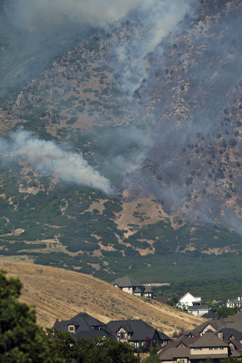 Chris Detrick  |  Tribune file photo
The Quail Fire burns above Alpine on July 3, 2013. Authorities have determined a track hoe sparked the fire, which cost about $1.3 million to suppress, but declined to prosecute those responsible.