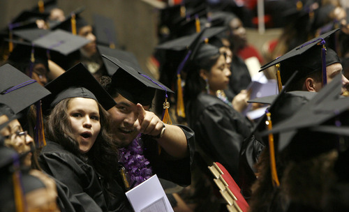 Francisco Kjolseth  |  The Salt Lake Tribune
Gema Naranjo, left, and Manuel Alfaro point out friends and family gathered in support of their graduation from Horizonte High during ceremonies at the Huntsman Center on the University of Utah campus on Wednesday, June 5, 2013.