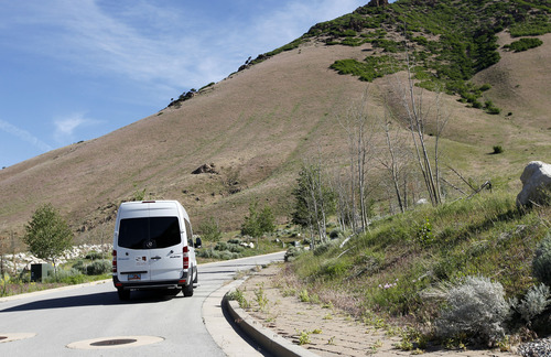 Al Hartmann  |  The Salt Lake Tribune
The Salt Lake County Planning Commission in a white van takes a driving tour of the proposed Tavaci Development site at the mouth of Big Cottonwood Canyon Friday June 7. Developer Terry Diehl is asking the county to rezone 47 acres for a high-density project after disconnecting from Cottonwood Heights, which did not go along with his request.