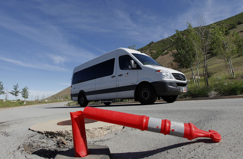 Al Hartmann  |  The Salt Lake Tribune
The Salt Lake County Planning Commission riding in the white van takes a driving tour of the proposed Tavaci Development site at the mouth of Big Cottonwood Canyon Friday June 7. Developer Terry Diehl is asking the county to rezone 47 acres for a high-density project after disconnecting from Cottonwood Heights, which did not go along with his request.