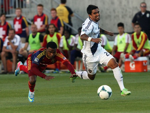 Kim Raff  |  The Salt Lake Tribune
(left) Real Salt Lake forward Robbie Findley (10) loses his footing as he and (right) Los Angeles Galaxy defender A.J. DeLaGarza (20) chase down a ball during the first half of a game at Rio Tinto Stadium in Salt Lake City on June 8, 2013.