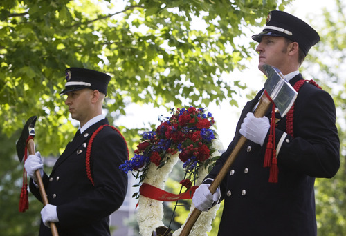 Kim Raff  |  The Salt Lake Tribune
Salt Lake City Honor Guard members (left) John Stevens and (right) Jared Schreiner stand guard at a memorial for Salt Lake City firefighter Lt. Paul Hamilton who was fatally injured 70 years ago while battling a hotel fire on a 100-foot ladder when the ladder collapsed at this spot on 400 South Main Street in Salt Lake City on June 10, 2013.