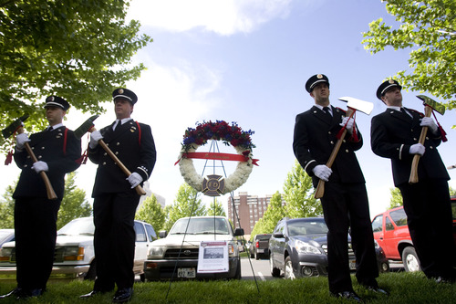Kim Raff  |  The Salt Lake Tribune
Salt Lake City Fire Department Honor Guard changes watch at a memorial for Salt Lake City firefighter Lt. Paul Hamilton who was fatally injured 70 years ago while battling a hotel fire on a 100-foot ladder when the ladder collapsed at this spot on 400 South Main Street in Salt Lake City on June 10, 2013.
