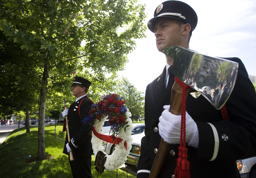 Kim Raff  |  The Salt Lake Tribune
Salt Lake City Honor Guard members (left) Daren Mortenson and (right) Jason Buhler stand guard at a memorial for Salt Lake City firefighter Lt. Paul Hamilton who was fatally injured 70 years ago while battling a hotel fire on a 100-foot ladder when the ladder collapsed at this spot on 400 South Main Street in Salt Lake City on June 10, 2013.