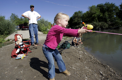 Tribune file photo
Clara Sandberg fishes with her dad Steve Sandberg and her cousin Trinity Sandberg on the banks Jordan River in September 2008. Utah's annual Free Fishing Day this year is June 8.