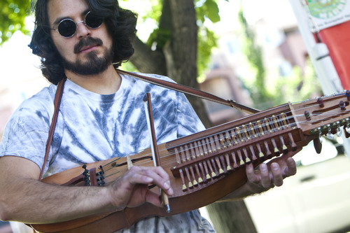 Chris Detrick  |  The Salt Lake Tribune
Spencer Rainer, of Highland, plays his Nyckelharpa (bowed key harp from Sweden) at the Downtown Salt Lake City Farmers Market in Pioneer Park Saturday June 8, 2013.