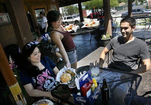 Scott Sommerdorf   |  The Salt Lake Tribune
Waitress Sarah Skeps delivers lunch orders to Janet Beagley, left, and James DeSpain as they lunch with other co-workers at Lucky 13 on Thursday. Utah-area readers mentioned Lucky 13 as one of their favorite burger places in Salt Lake City.