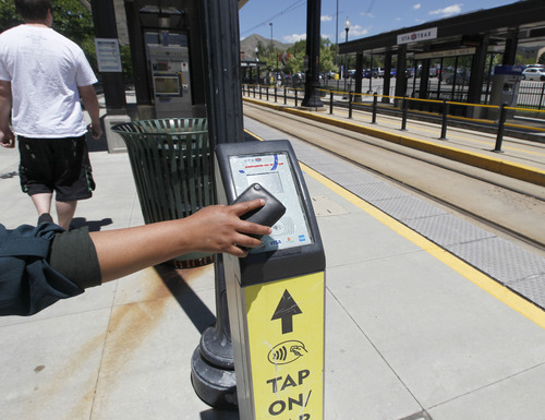Al Hartmann |  The Salt Lake Tribune
University of Utah student taps on to ride the TRAX train at University Station Wednesday June 5.   A quarter of UTA pass holders do not "tap off" after they "tap on." It wreaks havoc with planning, because it doesn't allow UTA to gather full data about where people travel.
