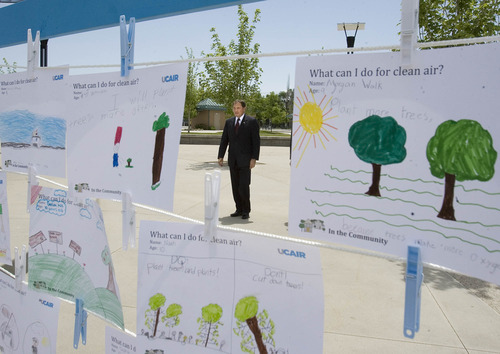 Paul Fraughton  |  The Salt Lake Tribune
As he walks toward the Fairbourne Station Plaza in West Valley City  for a UCAIR event Gov. Gary Herbert is framed by children's art showing examples of what can be done for clean air. Tuesday, June 11, 2013