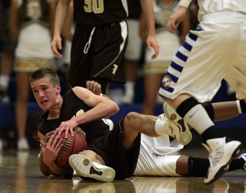Kim Raff  |  The Salt Lake Tribune
Davis player Jesse Wade tries to pick up a loose ball against Bingham during a game at Bingham High School in South Jordan on December 7, 2012. Davis went on to win the game.