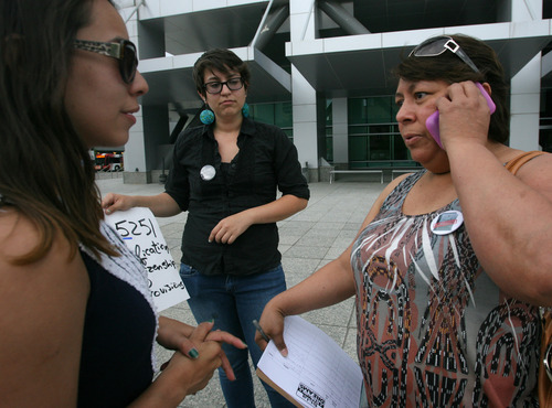 Rick Egan  | The Salt Lake Tribune 

Adriana Rodriguez (left) listens as Jacqueline Hernendez phones Sen. Orrin Hatch, during a vigil at the federal building, Wednesday, June 12, 2013. Immigrant youth with the Salt Lake Dream Team and community leaders launched a nightly vigil outside Sen. Orrin Hatch's federal building office to push the Senator to champion immigration reform.