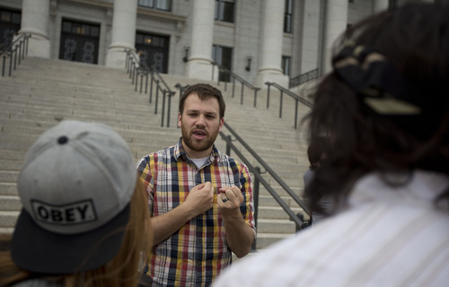 Lennie Mahler  |  The Salt Lake Tribune
Dan Garfield speaks with protesters about encryption software and other ways to protect personal data. About 25 turned out for a rally at the Utah State Capitol on Wednesday to oppose PRISM, an NSA program which stores citizens' personal phone records and internet usage metadata.