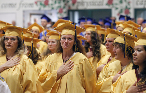 Al Hartmann  |  The Salt Lake Tribune
Women inmates hold their hand to their hearts during the flag ceremony at the Utah State Prison in Draper Wednesday June 11.   A record-high 360 men and women inmates graduated with high school diplomas and celebrated an important milestone on their paths toward returning to the community as law-abiding citizens. Another 140 inmates will likewise walk in a commencement ceremony at the Central Utah Correctional Facility in Gunnison on June 19.