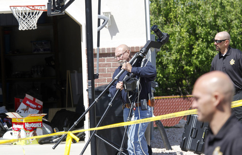 Al Hartmann  |  The Salt Lake Tribune
Davis County sheriff crime scene investigators look through the yard at 120 S. 1660 West in West Point last week. Two brothers, 4 and 10, were allegedly stabbed to death by their 15-year-old brother.
