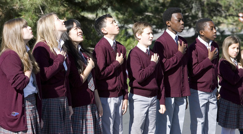 Paul Fraughton  |  The Salt Lake Tribune
After raising a giant American flag at Colonial Flag in Sandy on Friday, children from Challenger School recite the Pledge Of Allegiance. Two huge flags were raised simultaneously at the corporate headquarters of Colonial Flag and Challenger School.